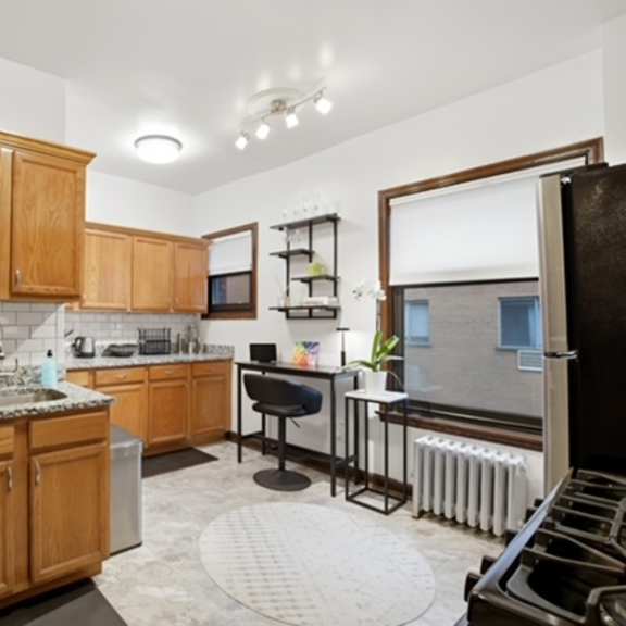 a kitchen with wooden cabinets and granite countertops.