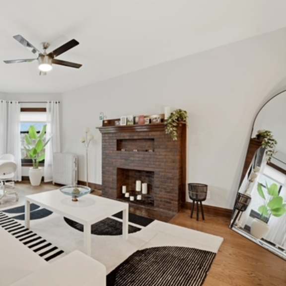 a living room with a white couch and a fireplace.