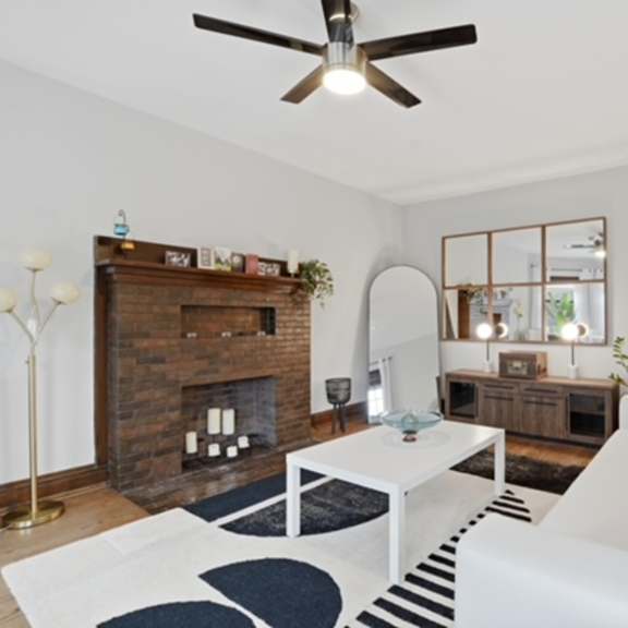 a living room with a fireplace and a white couch.