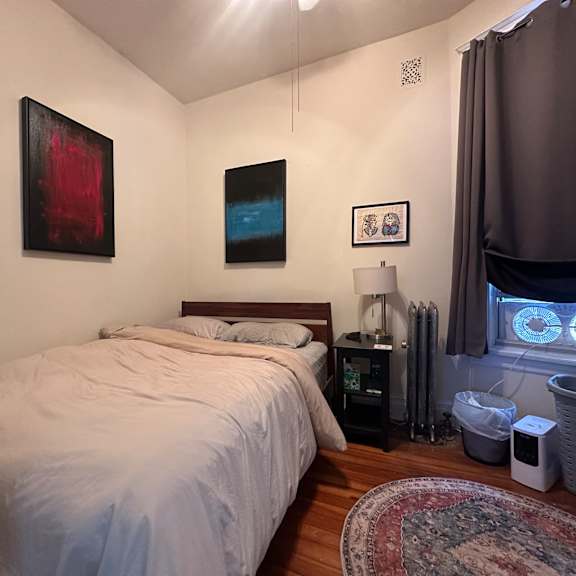 a bedroom with a large bed and a window with a view of the sky.