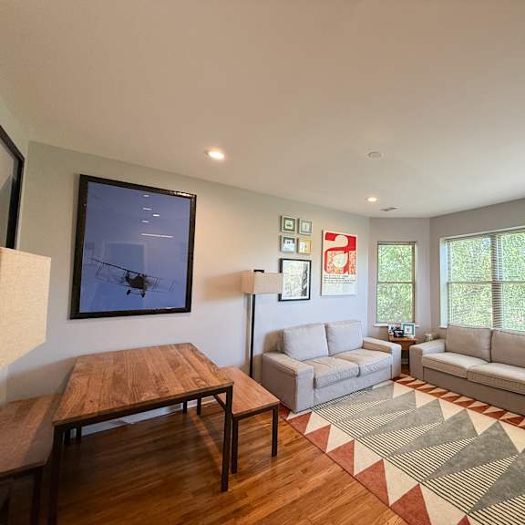 a living room with a wooden table and a couch.
