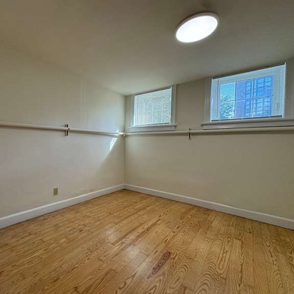 a room with wooden flooring and a window.