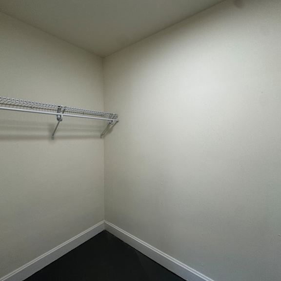 a white wall with a metal rack on it.