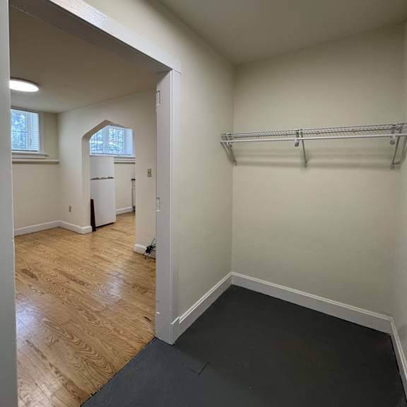 a room with a white wall and a black floor.