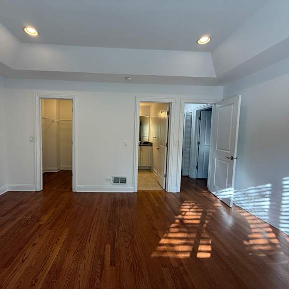 a room with wooden floors and white walls.