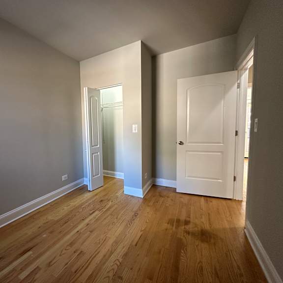 a room with wooden floors and white walls.