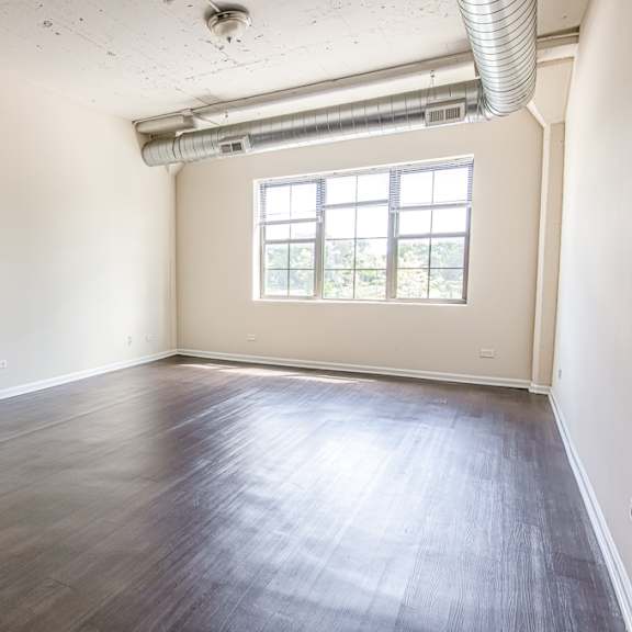 a room with wooden floors and a window.