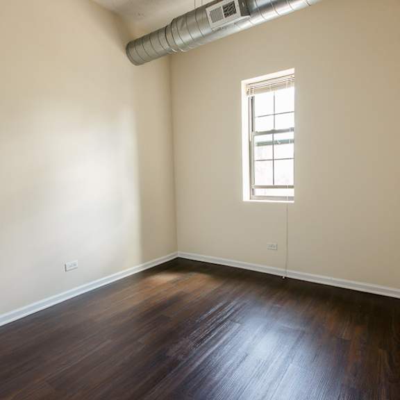 a room with wooden floors and a window.