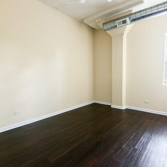 a room with wooden floors and a window.