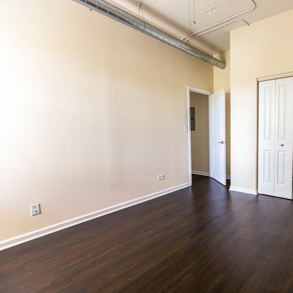a room with a wooden floor and white walls.