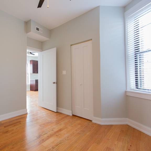 a room with wooden floors and white walls.
