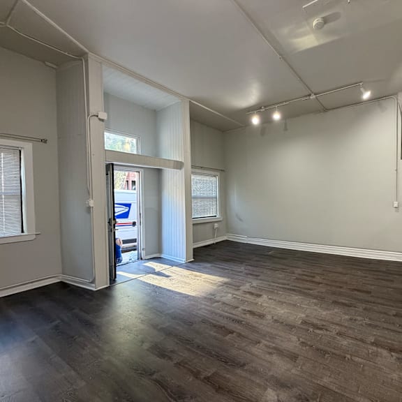 a room with a wooden floor and white walls.