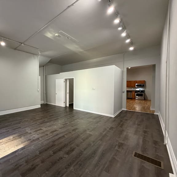 a room with wooden flooring and white walls.