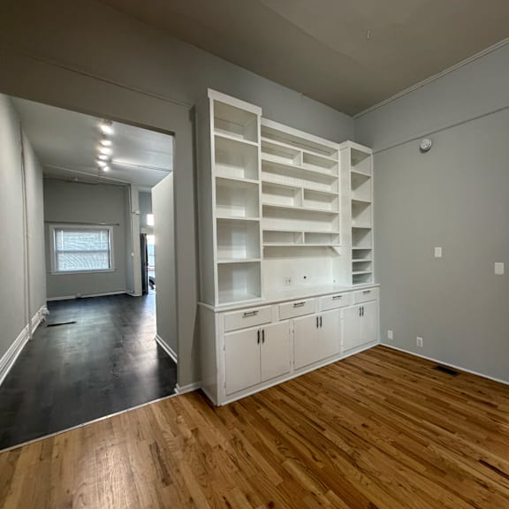a room with wooden floors and white walls.