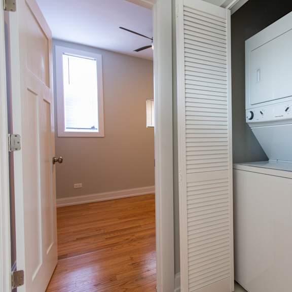 a white oven is in a kitchen with a wooden floor.