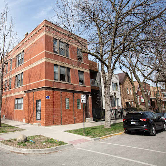 a red brick building with a blue sign on the front.
