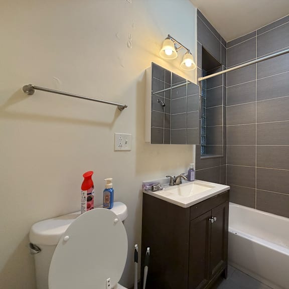a white toilet sits next to a sink in a bathroom.