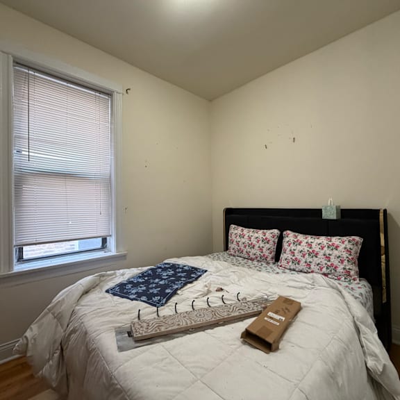 a bedroom with a bed, pillows, and a book on the bed.