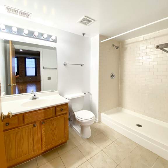 a white bathroom with a toilet, sink, and bathtub.