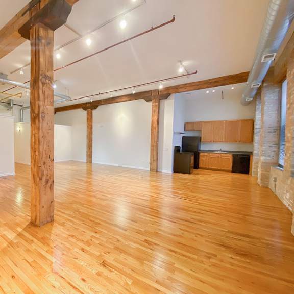 a room with wooden floors and a white ceiling.