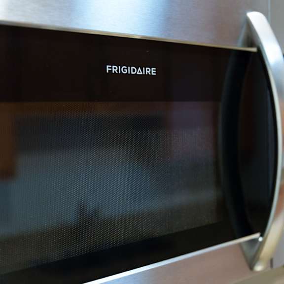 a stainless steel fridge-freezer with a digital display and control panel.