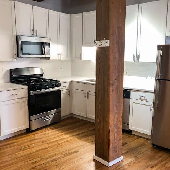 a kitchen with a refrigerator, stove, and oven.