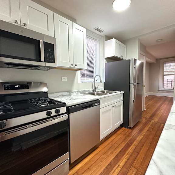 a kitchen with a stove, oven, and refrigerator.