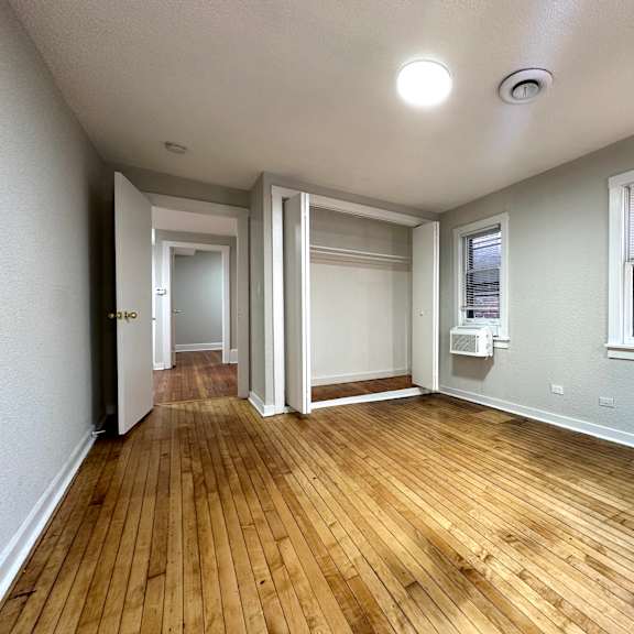 a room with wooden floors and white walls.