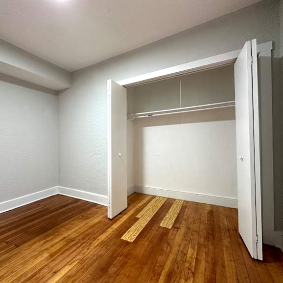 a room with a wooden floor and a white door.