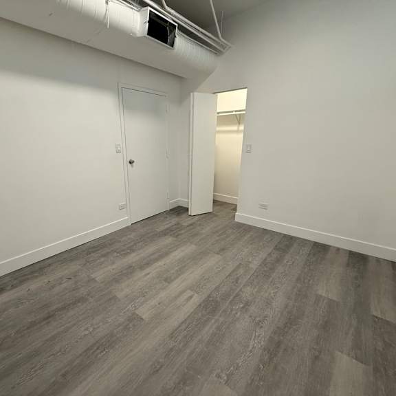 a room with a grey floor and a white door.