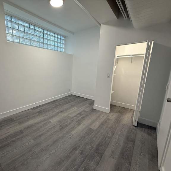 a room with a grey floor and a white door.