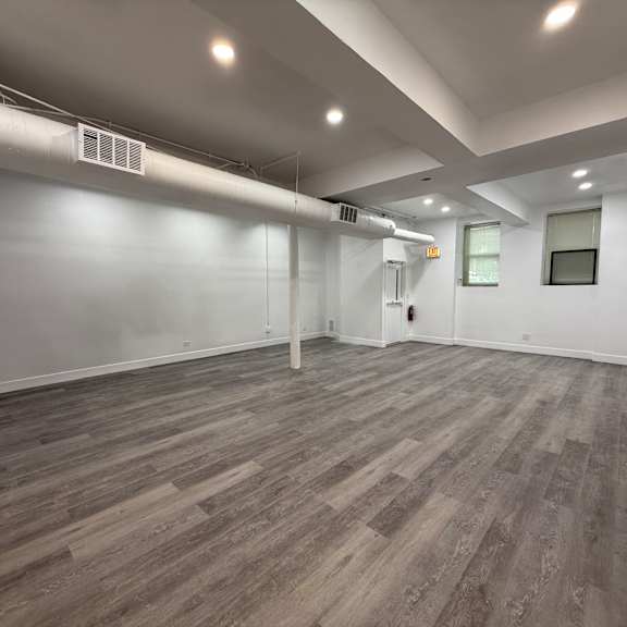 a room with wooden flooring and white walls.