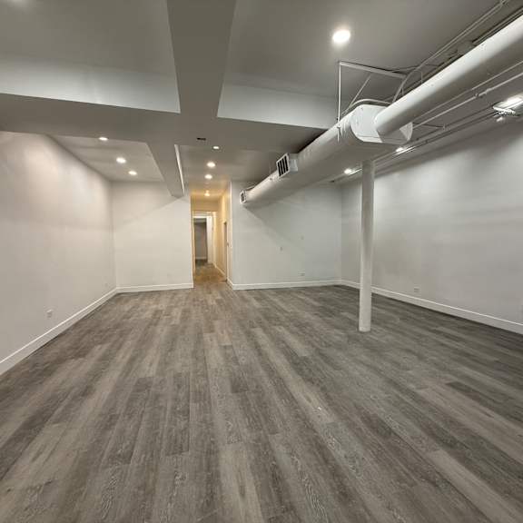 a room with a grey floor and white walls.