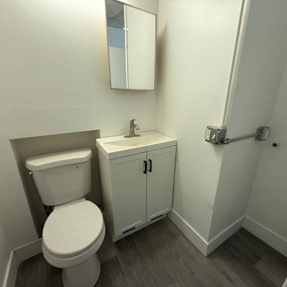 a white toilet and sink in a small bathroom.