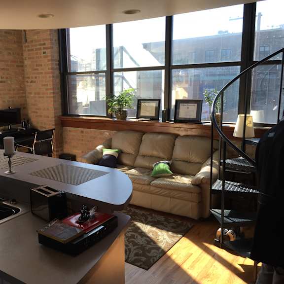 a kitchen with a couch and a table.