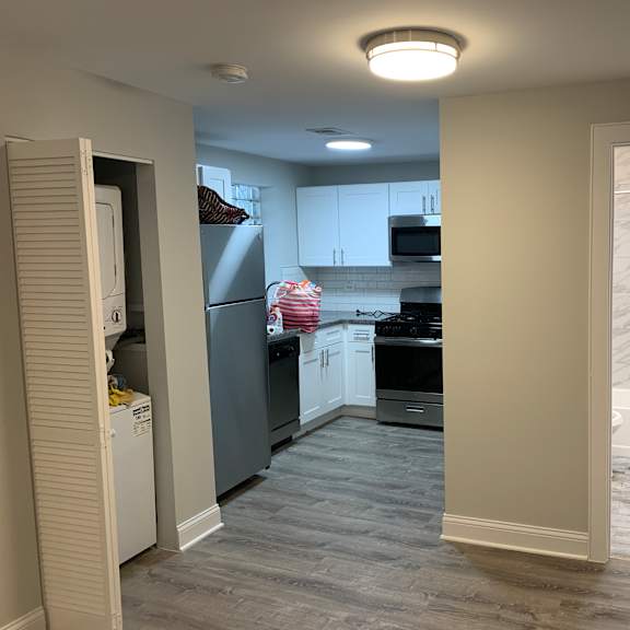 a kitchen with a refrigerator, oven, and cabinets.