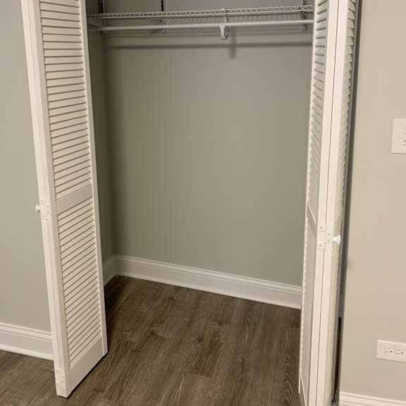 a white metal shelving unit with a door open.