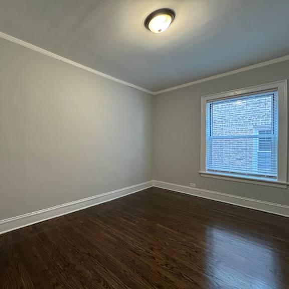 a room with a white door and a window with blinds.