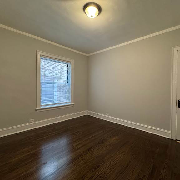 a room with a wooden floor and a white door.