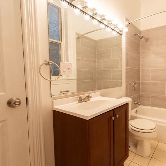 a bathroom with a white toilet and a white sink.