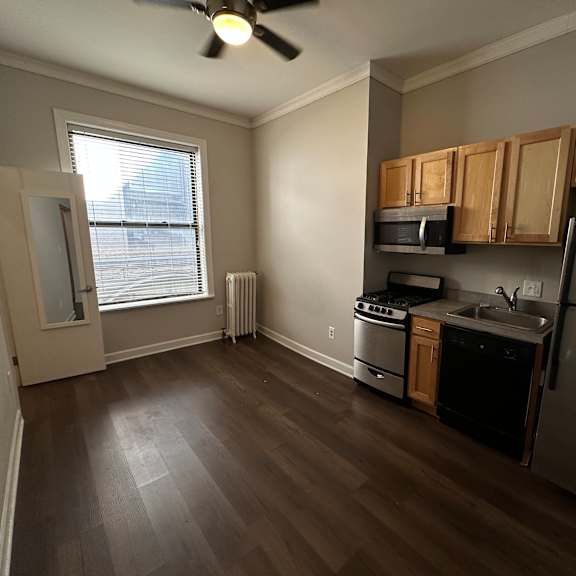 a kitchen with a refrigerator, stove, and microwave.