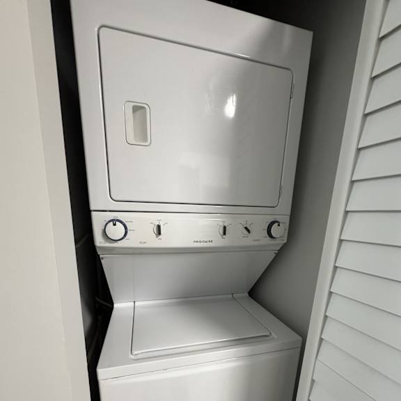a white washing machine and dryer in a small space.