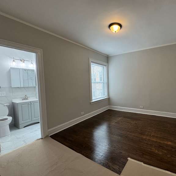 a room with wooden floors and white walls.