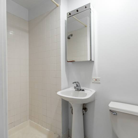 a bathroom with a sink toilet and a mirror