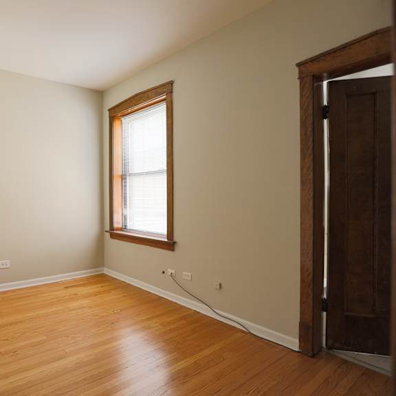 a room with a wooden floor and a window.