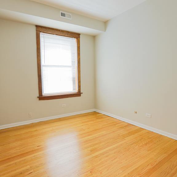 a room with a wooden floor and a window.