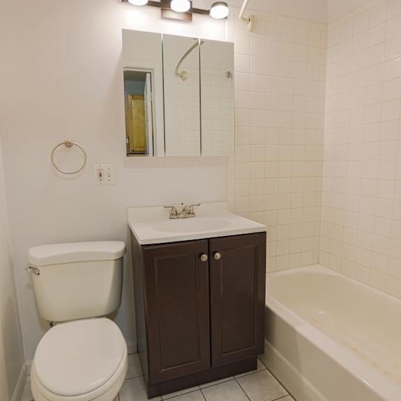 a white toilet sits next to a sink in a small bathroom.