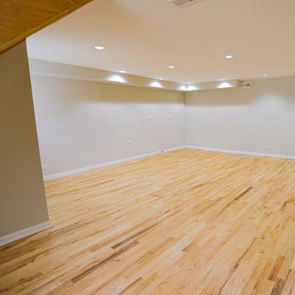 a room with wooden flooring and white walls.
