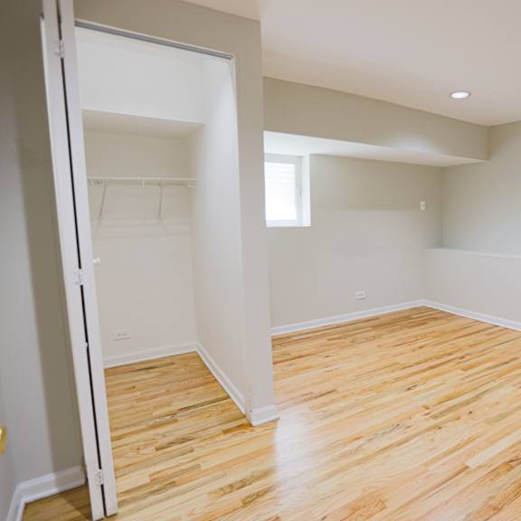 a room with wooden flooring and white walls.