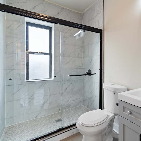 a white toilet sits next to a sink in a bathroom.